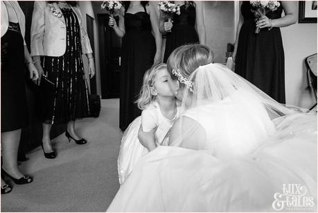 Bride kisses flower girl at York wedding