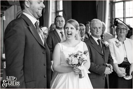Bride smiles and laughs as  she sees groom at York wedding