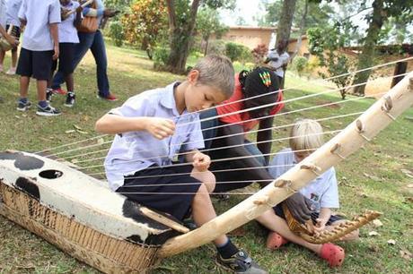 Young boy learning to play the adungu at Ndere Cultural Center, Kampala