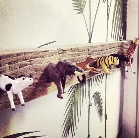 Plastic toy animals used as a coat rack