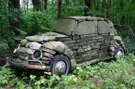 Black Volkswagen Beetle Covered in Stone