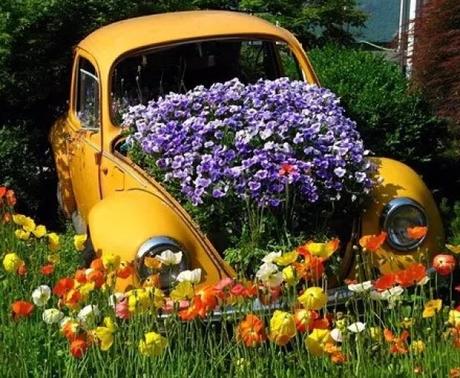 Yellow Volkswagen Beetle Covered in Flowers