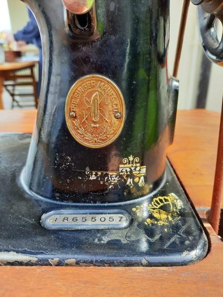 A silver plate usually hosts the Singer sewing machine serial number