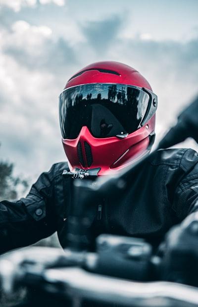 3 Powerful Meanings: What Does a Helmet Behind a Motorcycle Mean? 30 a person wearing a red helmet and black jacket sitting on a motorcycle