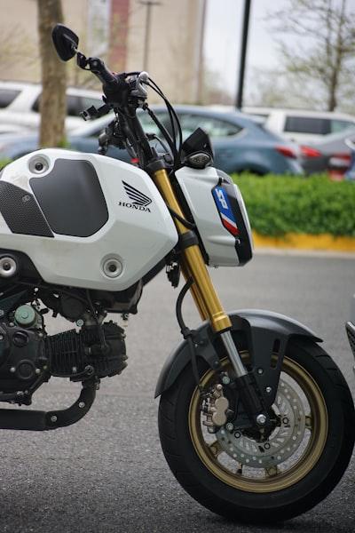 Jumpstart Your Legal Knowledge: Do You Need a Motorcycle License for a Honda Grom? 90 a white and black motorcycle parked in a parking lot