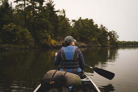 Waterways and Wilderness: Exploring Voyageurs National Park Minnesota 1 man in blue jacket and black backpack riding on white kayak on river during daytime, voyageurs national park minnesota