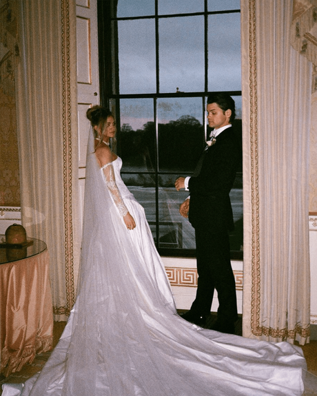 kate wasserbach and travis moore real wedding bride and groom standing near the window photo