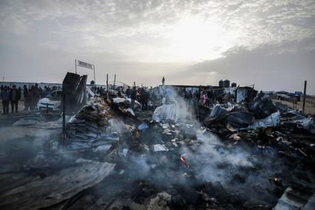 Palestinians look at the destruction after an Israeli strike where displaced people were staying in Rafah, Gaza Strip, Monday, May 27, 2024. Palestinian health workers said Israeli airstrikes killed at least 35 people in the area. Israel's army confirmed Sunday's strike and said it hit a Hamas installation and killed two senior Hamas members.