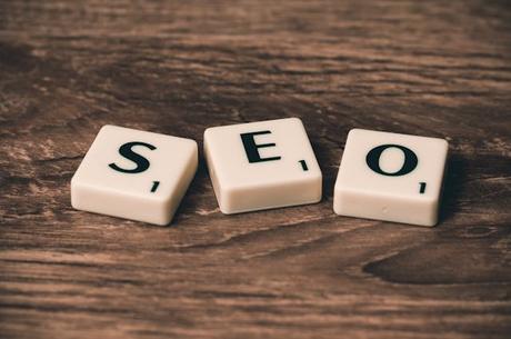 Can I Use Stock Images on My Website? Web Dev Secrets Unveiled a group of white tiles with black letters that read SEO on a wood surface
