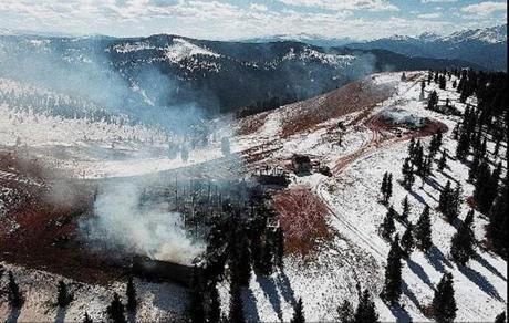 The Two Elk Lodge restaurant, foreground, on top of Vail Mountain burns along with another structure at right on Oct. 19, 1998, in Vail, Colo. (The Associated Press/File)