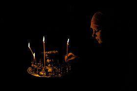 280px-Lighting_a_candle_in_Orthodox_church,_Ukraine