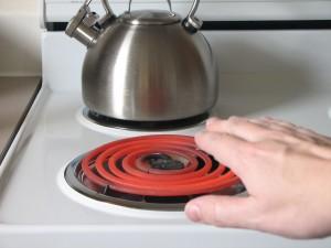 Hand approaches hot burner