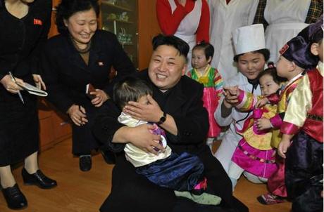 Kim Jong Un embraces a boy during a visit to a Pyongyang orphanage and baby home (Photo: Rodong Sinmun).