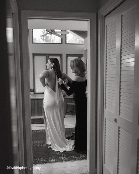 documentary style wedding photography mom helps the bride dress