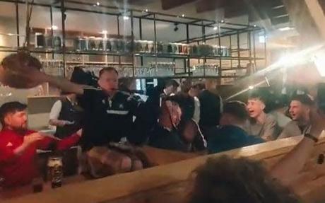 Watch: Scotland fan falls off pub table while playing bagpipes as Tartan army descends on Munich