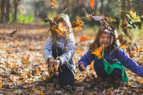 Caregivers and children Photo of Children Playing With Dry Leaves