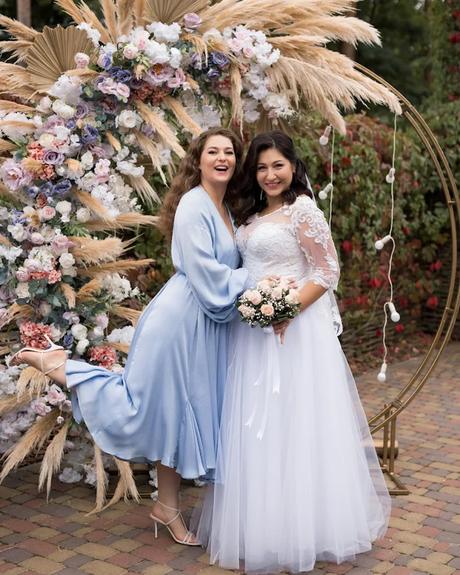 wedding forward chiefs editor real wedding bride and wedding guest posing in front of wedding arch