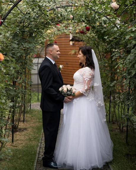 wedding forward chiefs editor real wedding bride and groom looking at each other under arch