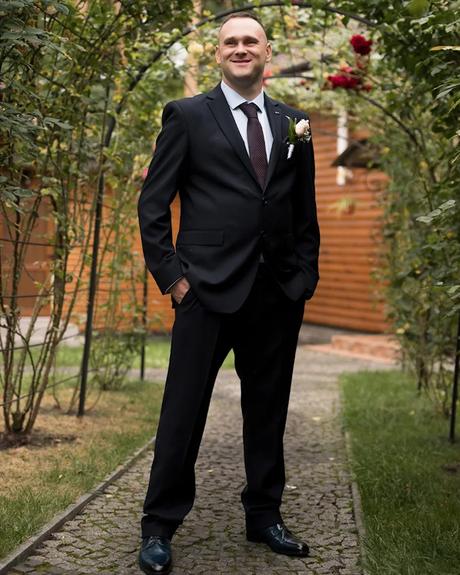 wedding forward chiefs editor real wedding groom smiling posing under the floral arch