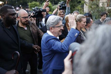 Projections show voters rejecting the far right : NPR The founder of left-wing party France Unbowed, Jean-Luc Mélenchon, waves at supporters on the election night in Paris on Sunday.