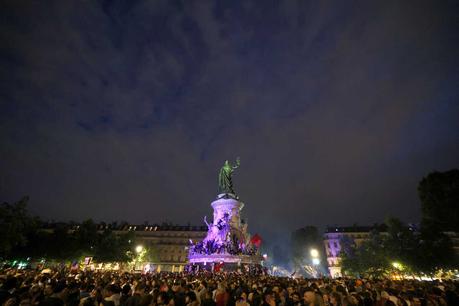 Participants gather during an election night rally following the first results of the second round of France's legislative election at Place de la Republique in Paris on Sunday.