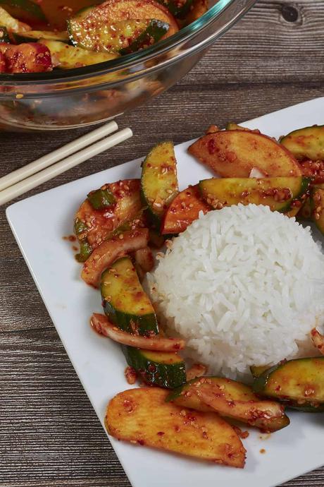 white rice surrounded by korean cucumber salad (oi muchim)