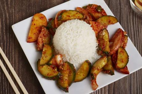 white rice surrounded my korean cucumber salad