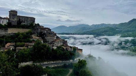 Atmospheric photo of the hilltop village of Roviano with low hanging mist in the valley and the hilltop settlement rising above