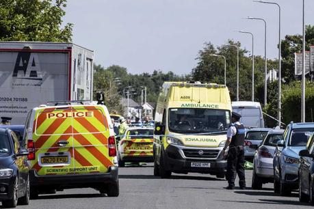 Emergency services work at the scene in Southport, England, where a man has been detained and a knife has been seized after a number of people were injured in a reported stabbing on Monday.