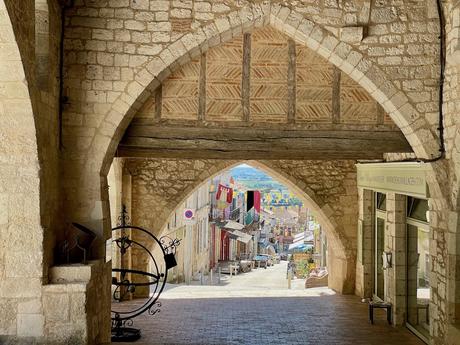 Attractive archways in the covered medieval arcade in the centre of Monflanquin in Lot et Garonne