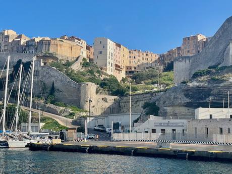 The fortified citadel of Bonifacio in Corsica viewed from the water of the harbour with defensive walls and pleasure yachts side by side