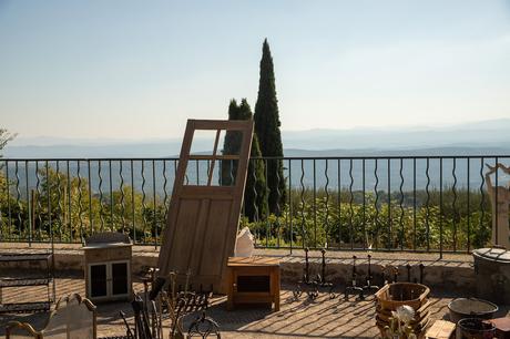 Market day in Tourtour with a range of random assortments including an old wooden door on display in the square and expansive views of the green provoncal countryside beyond