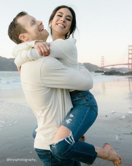 engagement photo captions guy holging his sweetheart in jeans on his arms