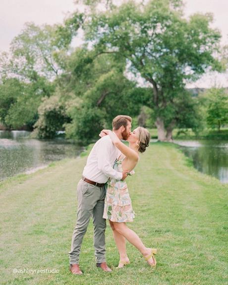 engagement photo captions love couple kissing outside near the lake