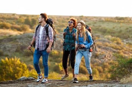 young travelers hiking and smiling