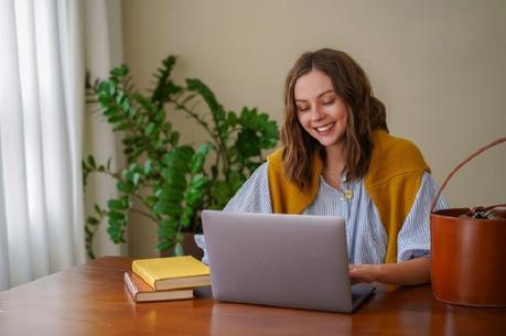 girl smiling and using laptop