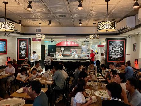 Interior of Juliana's Pizza in Brooklyn full of diners