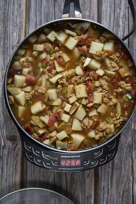 adding the broth and potatoes for vegan picadillo