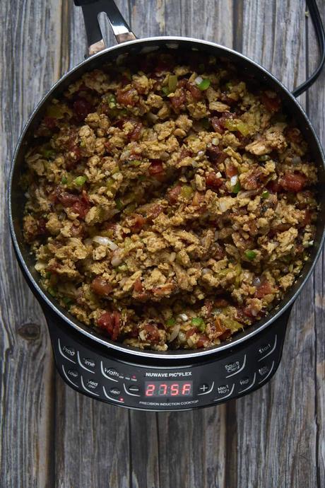 adding the spices and tomatoes for vegan picadillo