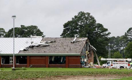 Parts of Springfield Middle School lay on the ground after being ripped off by a tornado, spawned by Tropical Storm Debby, in Lucama, North Carolina, Thursday.