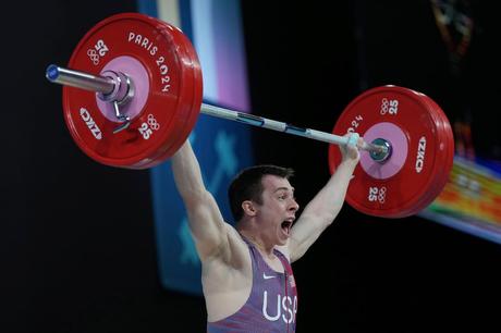Hampton Morris of the United States competes during the men's 61kg weightlifting event at the...