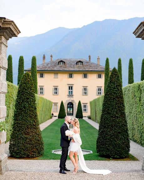 angelina and vladyslavs wedding bride and groom posing in front of the villa