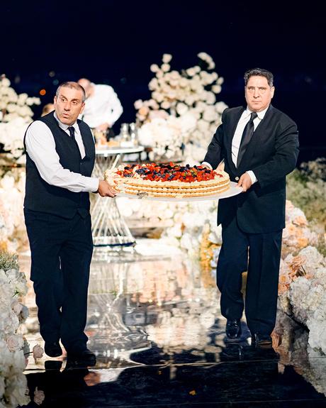 angelina and vladyslavs wedding twi men carry italian cake