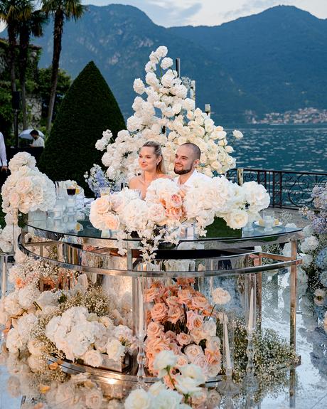 angelina and vladyslavs wedding newlyweds sitting behind sweetheart table