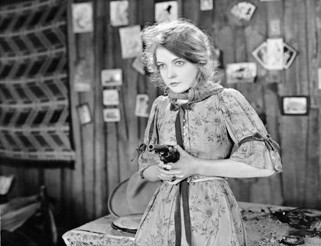 Lillian Gish holds a gun in 1928's The Wind.