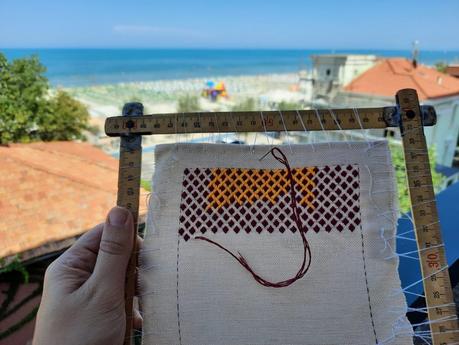 Brick stitch embroidered needle roll: working on vacation