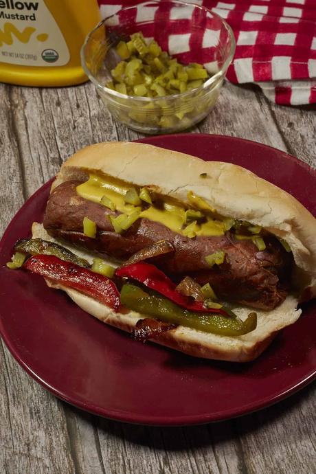 vegan Italian sausage on a bun with grilled onions and peppers