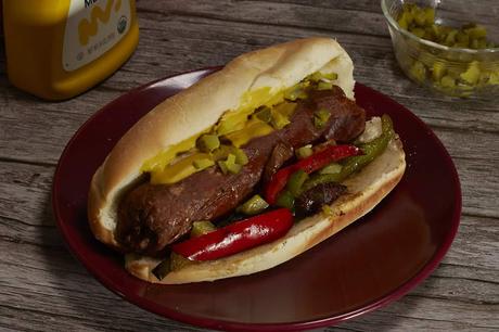 vegan Italian sausage on a bun with grilled onions and peppers