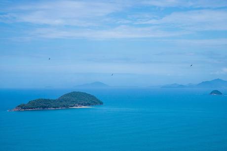 Small green islands surrounded by deep blue sea off the coast of southern Brazil.