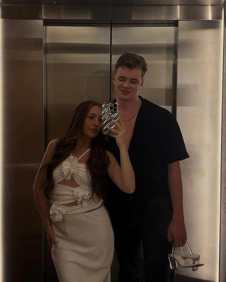 proposal story of sydney nicole gifford nathan sloneker man and woman making a photo in elevator sydneynicolegiff